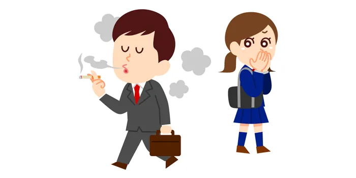 タバコを吸っている男性を不快そうに見る女性